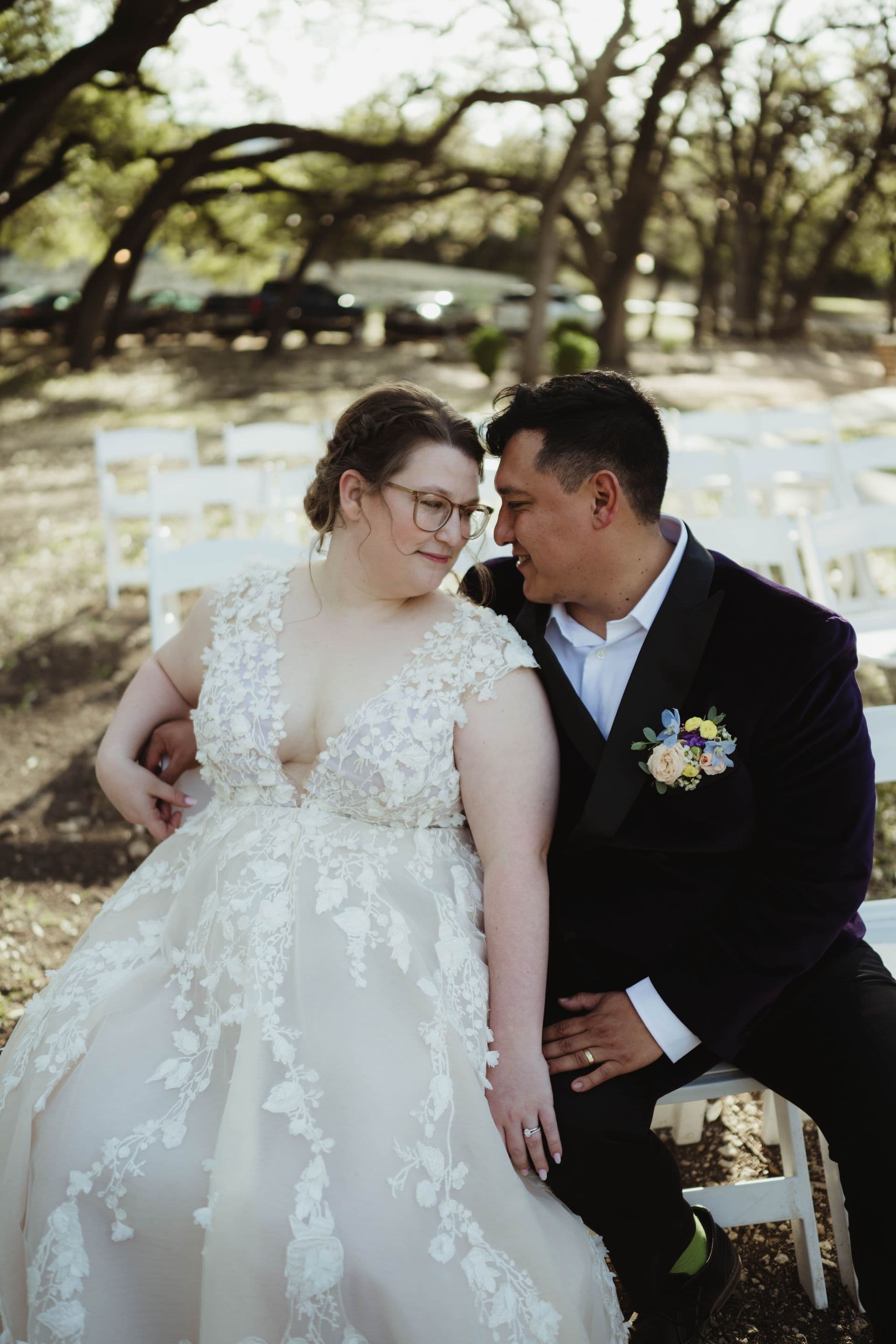 Dan and Rachel leaning together under the oak trees at Scenic Springs