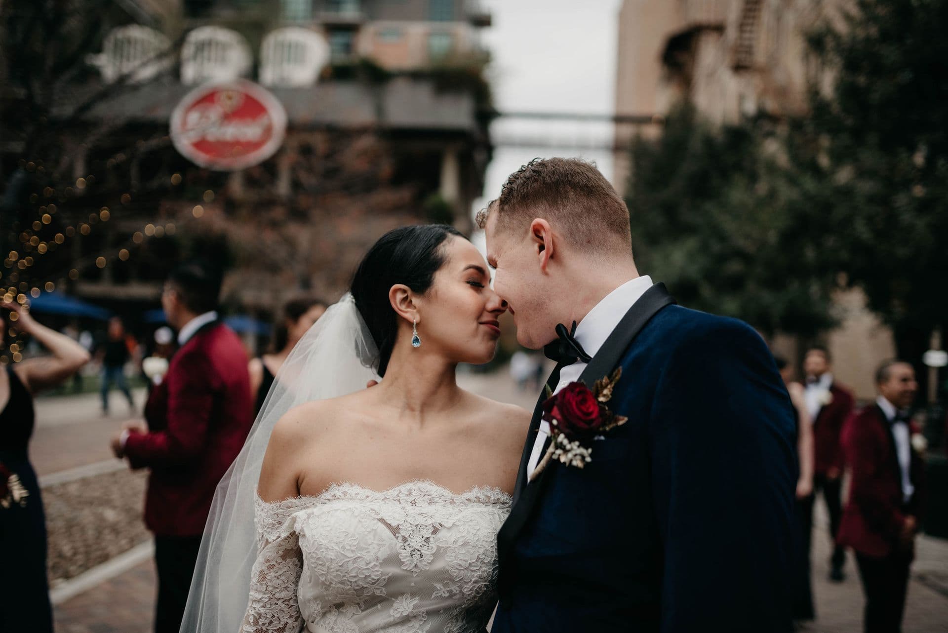A newly married couple kissing on a downtown San Antonio street